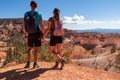 Couple holding hands with scenic aerial view from Fairyland hiking trail on massive hoodoo sandstone rock formations Royalty Free Stock Photo