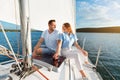 Couple Holding Hands Sitting On Sailboat Deck Enjoying Sailing Tour