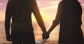 Couple, holding hands and sunset beach sky with love on vacation, holiday or adventure. Silhouette of man and woman Royalty Free Stock Photo