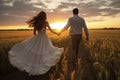 Couple Holding Hands in Sunset Wheat Field Royalty Free Stock Photo