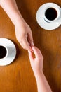 Couple holding hands on the table in the cafe Royalty Free Stock Photo