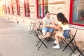 Couple holding hands at the table on the street