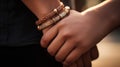 A couple holding hands with two bracelets, AI Royalty Free Stock Photo