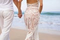 Couple holding hands and walking on the beach Royalty Free Stock Photo