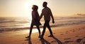 Couple holding hands, walking on beach at sunset and ocean with silhouette, vacation and travel with mockup space. Love Royalty Free Stock Photo