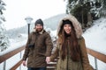 Couple holding hands and walking on stairs in winter mountains Royalty Free Stock Photo