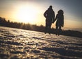 Couple holding hands in winter sunset.