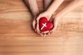 Couple holding heart with cross symbol on background, top view. Christian religion Royalty Free Stock Photo