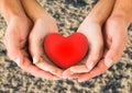 Couple holding heart shape in cupped hands Royalty Free Stock Photo