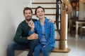 Couple holding house key while sitting on stairs Royalty Free Stock Photo