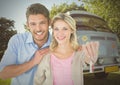Couple Holding key in front of camper van Royalty Free Stock Photo