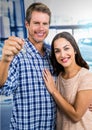 Couple Holding key in front of cars Royalty Free Stock Photo