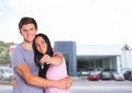 Couple Holding key in front of cars Royalty Free Stock Photo