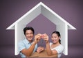 Couple Holding key with house icon and boxes in front of vignette Royalty Free Stock Photo