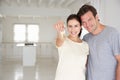 Couple holding keys in new home Royalty Free Stock Photo