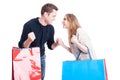 Couple holding shopping bags making winning gesture feeling happy Royalty Free Stock Photo