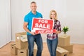 Couple holding sold sign Royalty Free Stock Photo