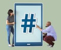 Couple holding tablet icons with hashtag
