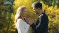 Couple holding and warming hands in cold autumn day, taking care of beloved Royalty Free Stock Photo