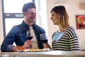 Couple holding wineglass at counter