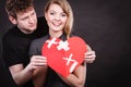 Couple holds broken heart joined in one Royalty Free Stock Photo