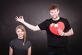 Couple holds broken heart joined in one Royalty Free Stock Photo