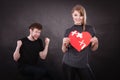 Couple holds broken heart joined in one Royalty Free Stock Photo