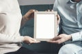 the couple holds frame photo