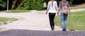 Couple holds hands. The girl walks with her boyfriend holding hands. couple in love walking in the park.