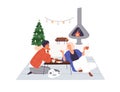 Couple at home at Christmas. Happy man and woman relaxing by fireplace in evening. Family drinking cacao, talking at Royalty Free Stock Photo