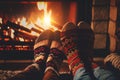 Young romantic couple sitting on sofa in front of fireplace, Warming and relaxing near fireplace.