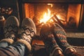 Young romantic couple sitting on sofa in front of fireplace, Warming and relaxing near fireplace.