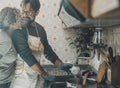 Couple at home in domestic activity together washing dishes in the kitchen. Real life at home with mature man and woman after