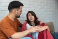 Couple at home. Handsome young man is calming his upset crying wife while holding her shoulders and apologizes. People, Royalty Free Stock Photo