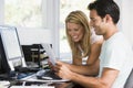 Couple in home office with computer and paperwork Royalty Free Stock Photo