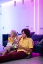 Couple at home playing video games. Girl hug the boy and holding joystick in her hands. Spendning time together at home. Royalty Free Stock Photo