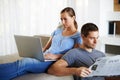 Couple, home and relax or news on laptop, reading and bonding together in silence on couch. People, newspaper and woman Royalty Free Stock Photo