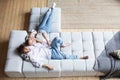 Couple at home relaxing in sofa top view. Domestic life Royalty Free Stock Photo