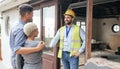 Couple, home rennovation and construction builder shaking hands for congratulations on new house, real estate purchase