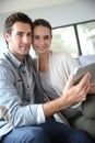 Couple at home websurfing on tablet Royalty Free Stock Photo