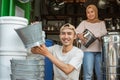 Couple of homeware shop owner smiling when look at camera while checking the stock of goods