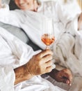 Couple honeymoon trip and having prosecco in bed Royalty Free Stock Photo