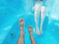 Couple in hot tub, underwater shot of male and female legs in water Royalty Free Stock Photo