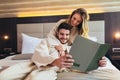 Couple in hotel room reading room service menu together Royalty Free Stock Photo