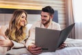 Couple in hotel room reading room service menu together Royalty Free Stock Photo