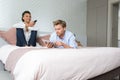 Couple in hotel room using remote control and tablet computer Royalty Free Stock Photo