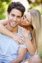 Couple, hug and happy in park with smile, love and commitment in healthy relationship. People on a date outdoor