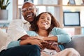 Couple, hug and laughing on sofa portrait in home living room, bonding and having fun. Interracial, love and funny black Royalty Free Stock Photo