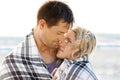 Couple, hug and love by ocean for travel, vacation and relax in summer by nature with care. Man, woman and embrace on