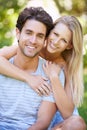 Couple, hug and portrait in park with smile, love and commitment in healthy relationship. People on date outdoor